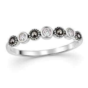 silver band ring featuring an alternating pattern of small, round, clear stones and dark stones