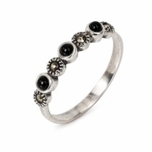 A silver ring featuring round black stones and small dark stones.