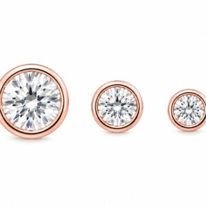 Three rose gold stud earrings in varying sizes, each featuring a round clear stone