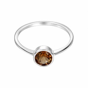 A silver ring featuring a round orange stone.