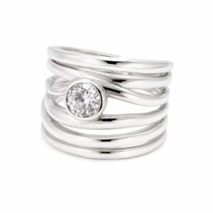 A multi-band silver ring featuring a round clear stone.