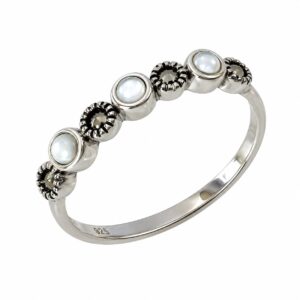 silver ring featuring round white pearls and small dark stones.