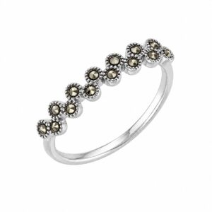 A silver ring featuring a row of dark, round stones.
