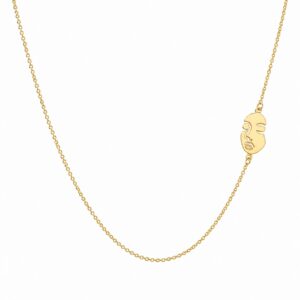 gold chain necklace featuring a small, asymmetric gold charm in the shape of a stylized face